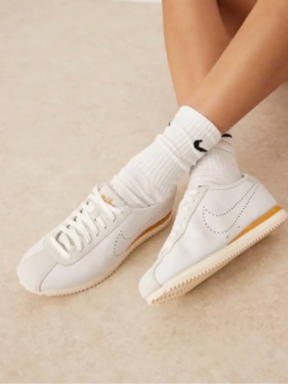Nike White Women's Sneakers with Gold Accent